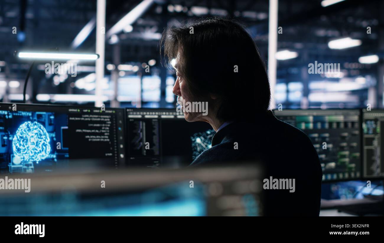 Programmer programs on a computer workstation in a server room with generative AI assistance. Stock Photo