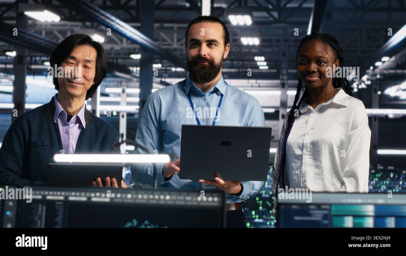 Engineers program on a computer workstation in a data center with generative AI assistance. Stock Photo