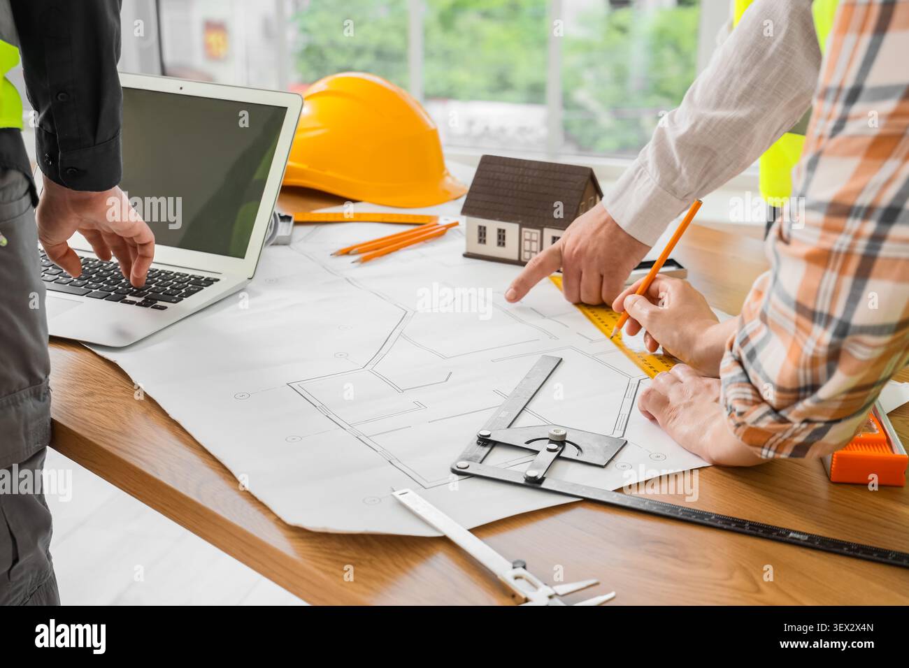 Architects working on house blueprint with tools and laptop Stock Photo