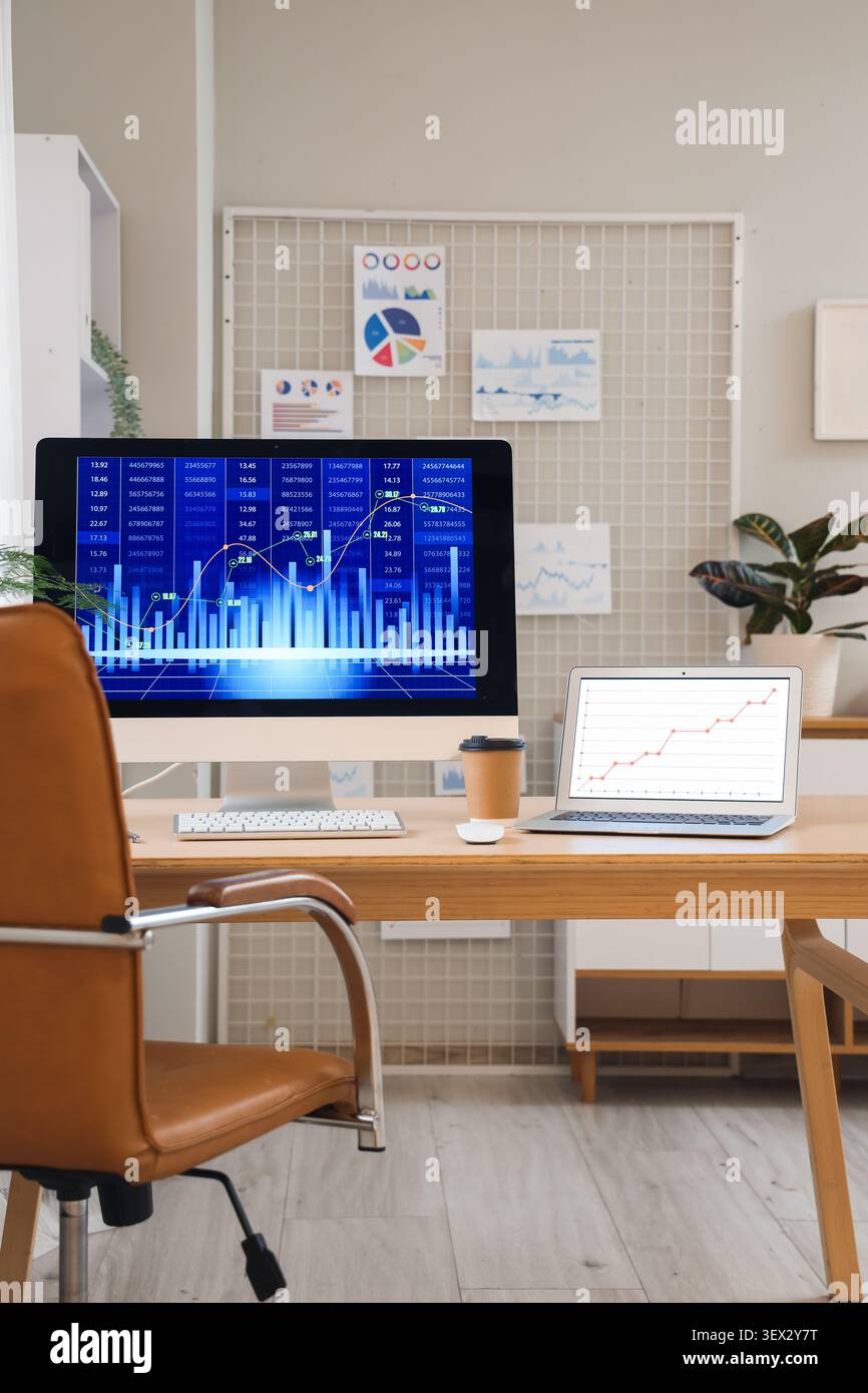 Data scientists workplace with computer and diagrams in office Stock Photo