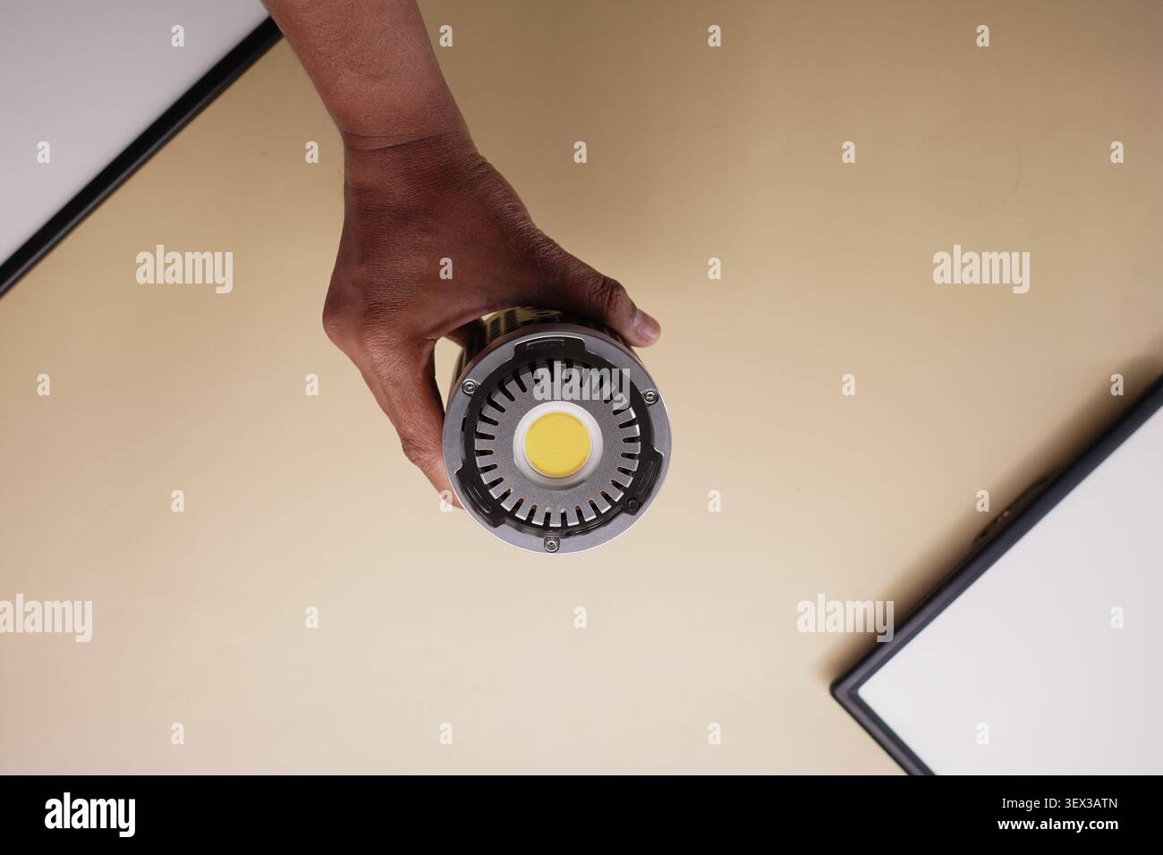 Holding a round flashlight in a person's hand Stock Photo