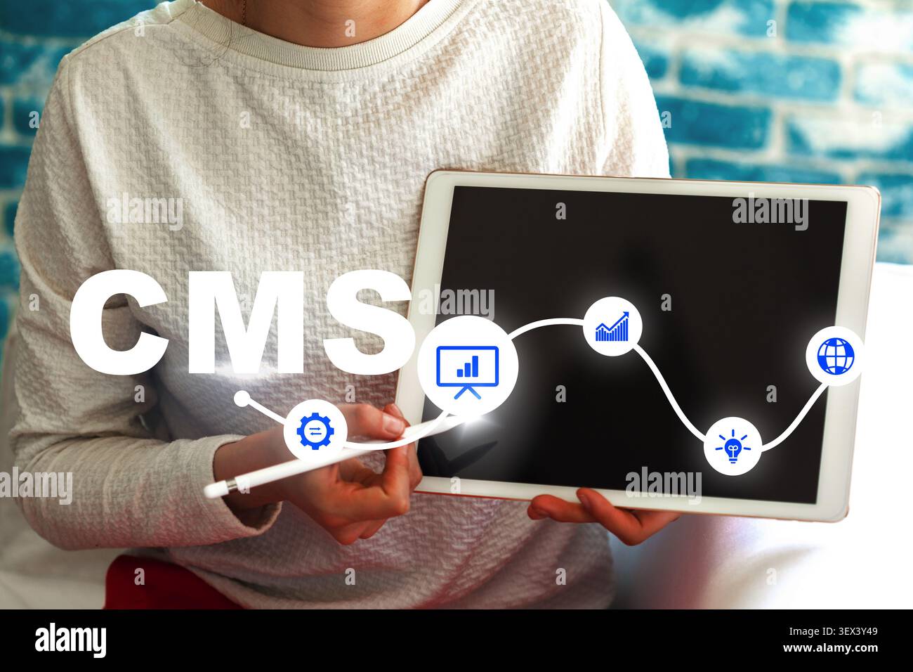 Using a content management system on a tablet for online tasks Stock Photo
