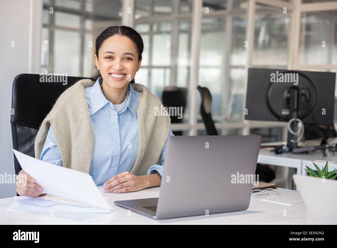 Happy female manager looking at camera Stock Photo