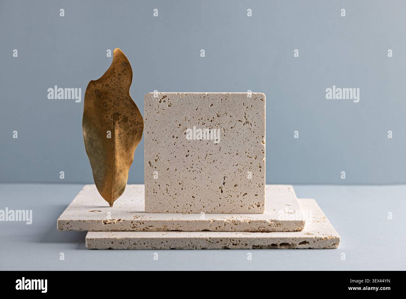 Minimalist Stone and Leaf Composition on Blue Background for Modern Design Stock Photo