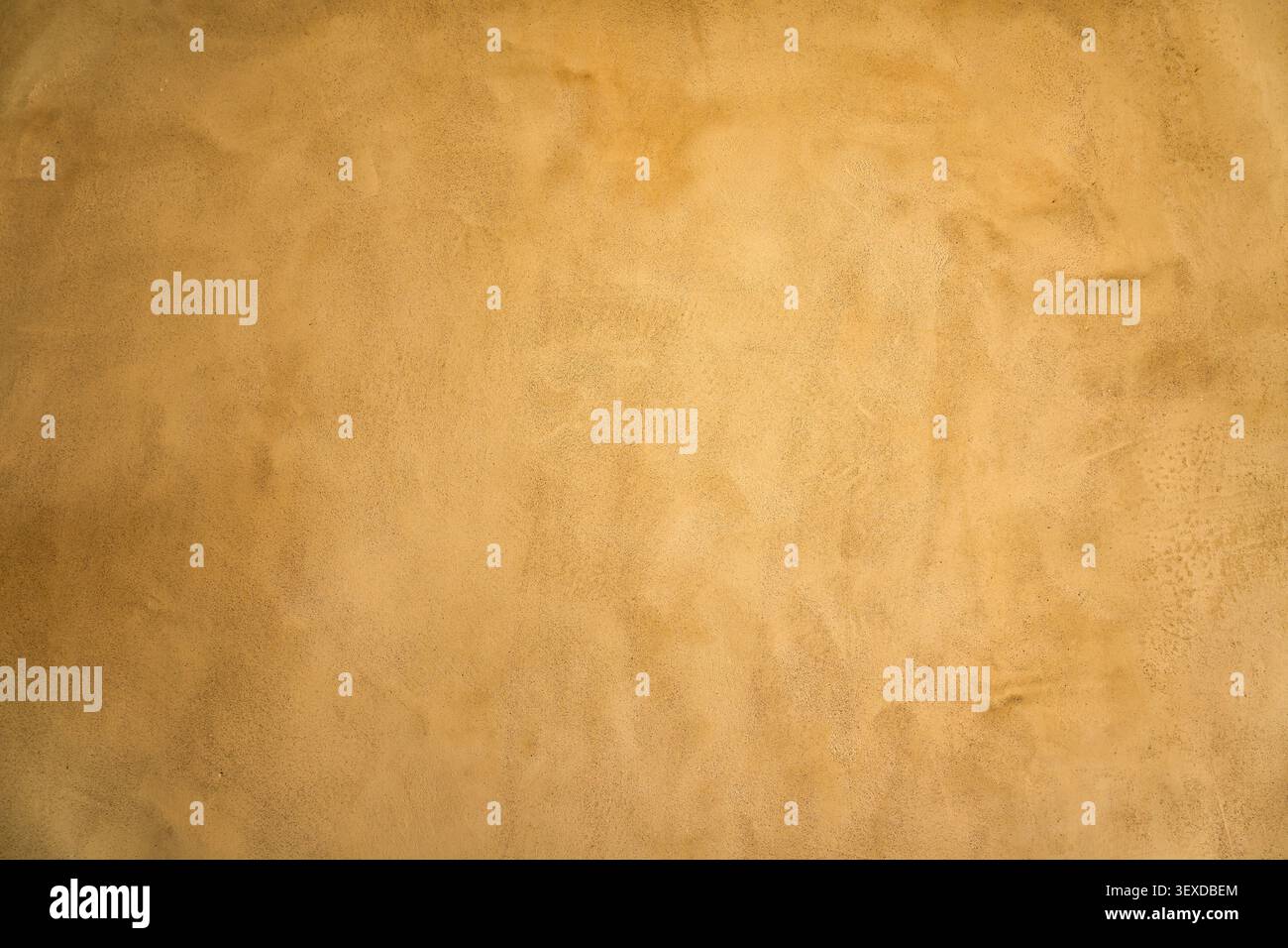 Earthy beige stucco wall surface showing rough natural texture plaster with subtle color gradient for background Stock Photo