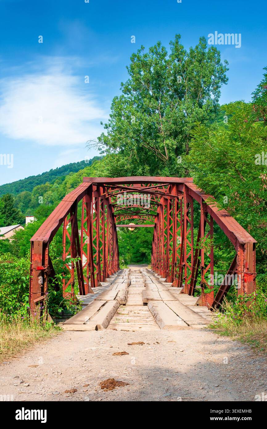 rail bridge in mountain landscape in summertime. outdoor adventures in highland of ukraine, rakhiv district on a sunny day Stock Photo