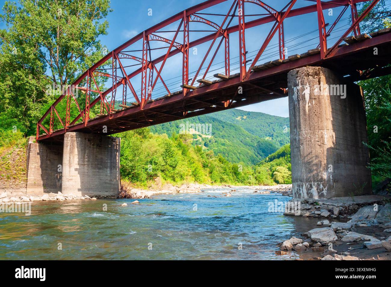 rail bridge in mountain landscape in summertime. outdoor adventures in highland of ukraine, rakhiv district on a sunny day Stock Photo