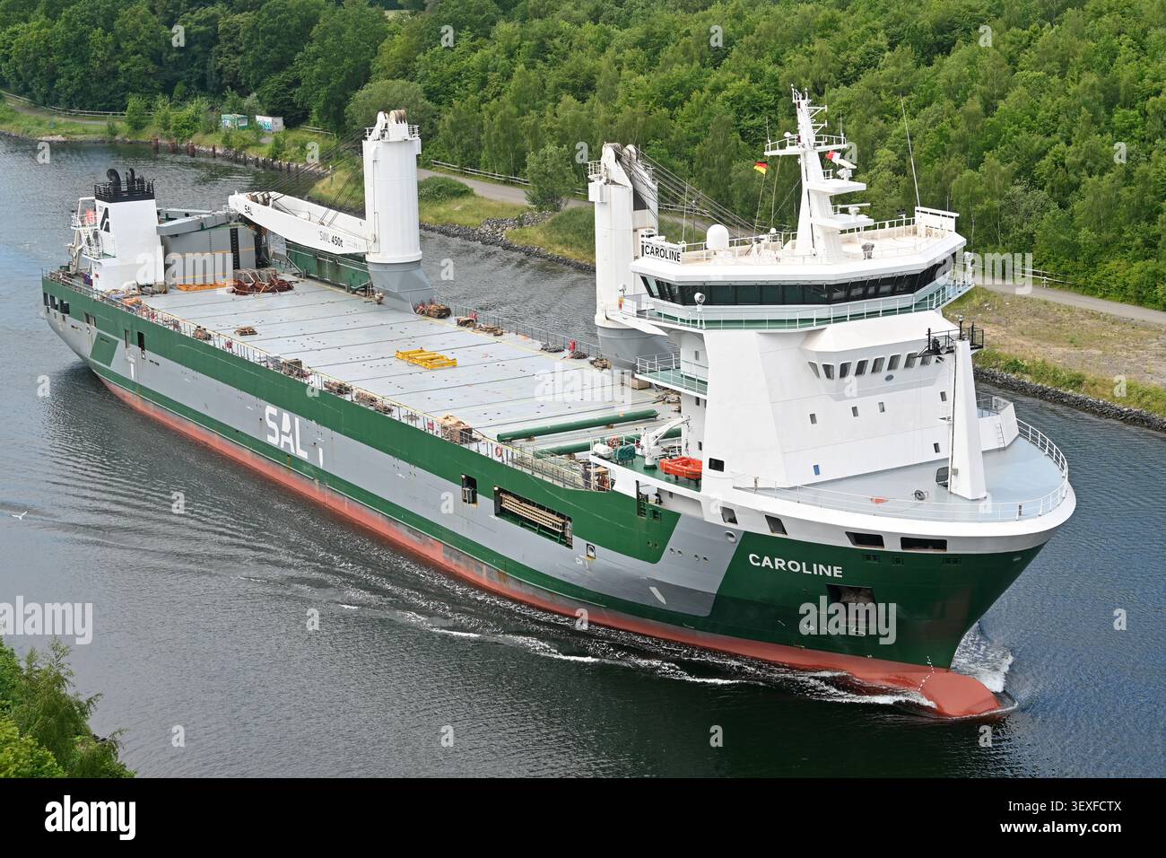 General cargo ship CAROLINE passing the Kiel canal Stock Photo
