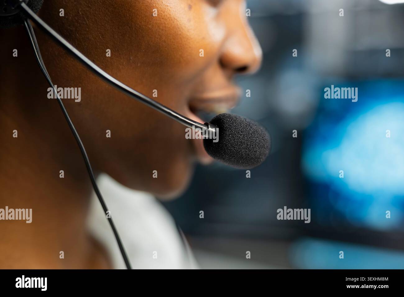 Administrator wears a headset in a server hub, using artificial intelligence troubleshooting to assist users. Stock Photo