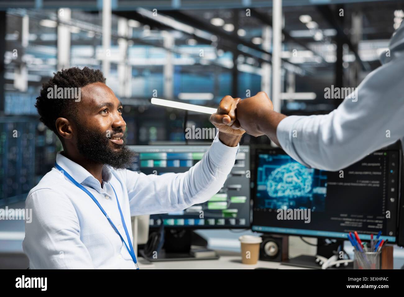 Data center engineer reviews artificial intelligence systems and machine learning processes inside a data center. Stock Photo