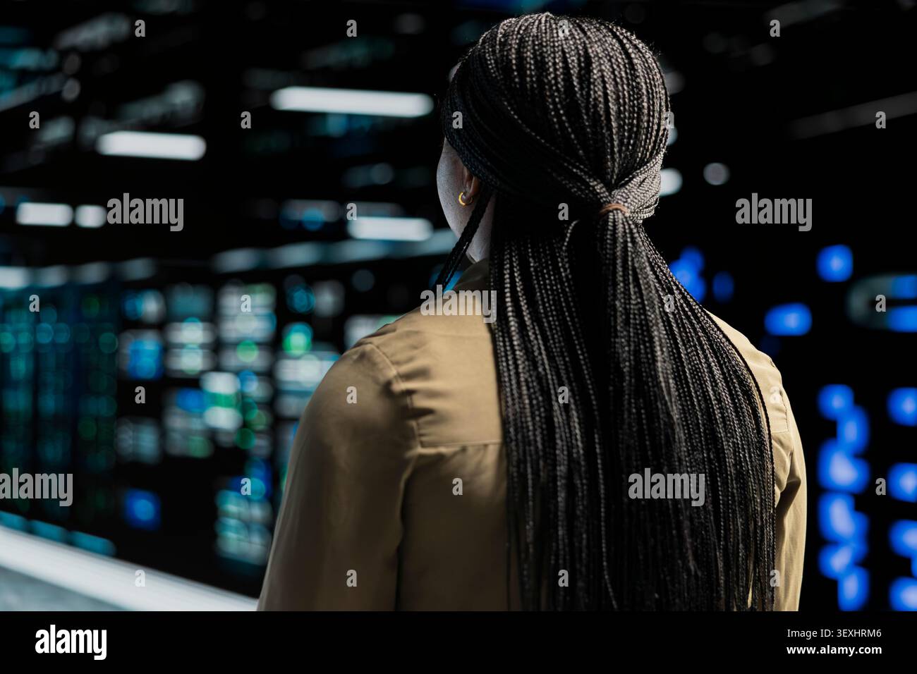 Data center engineer inspects server infrastructure, performs maintenance checks and reviews equipment diagnostics. Stock Photo