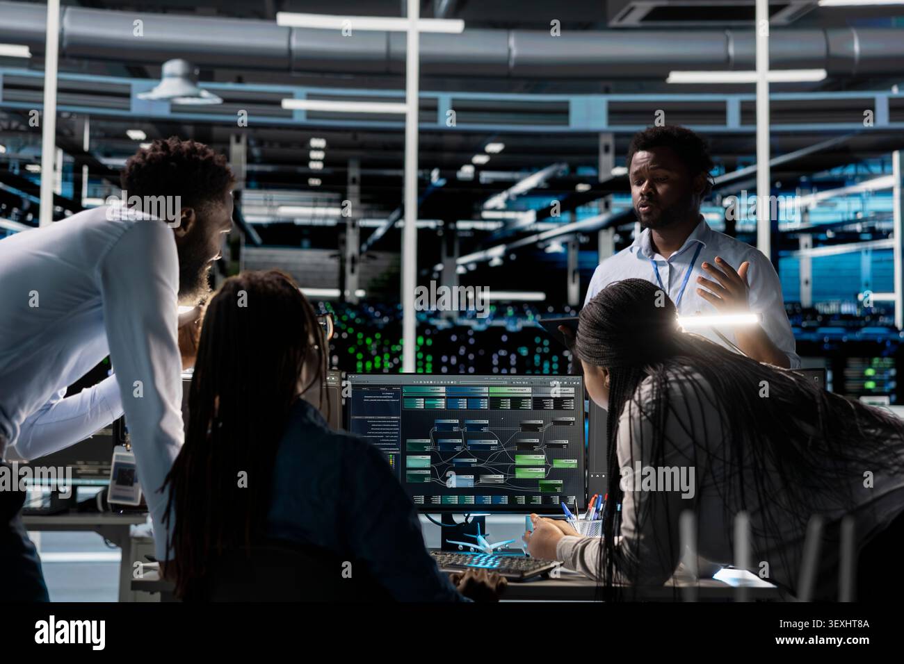 Engineering team uses a PC in a data center to visualize interconnected AI neural networks while overseeing information processing systems. Stock Photo