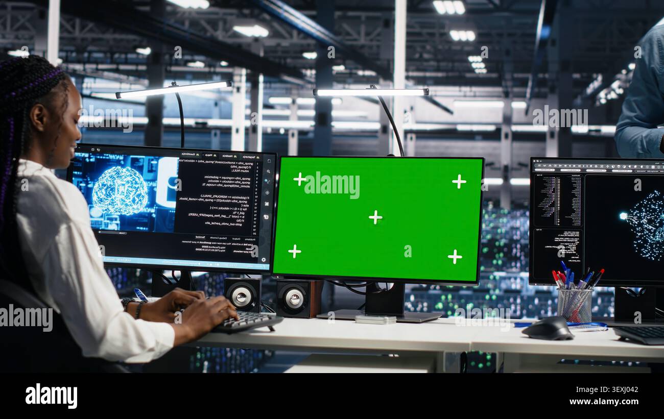 IT colleagues collaborate in a data center while reviewing AI diagnostics and infrastructure performance. Stock Photo
