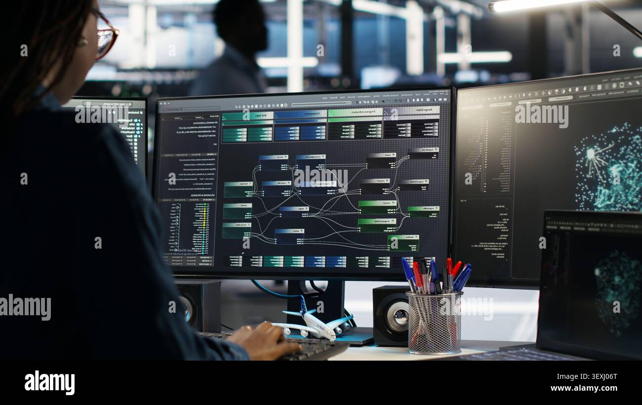 Engineer reacts with frustration in a server farm as node tree systems fail to categorize unstructured data. Stock Photo
