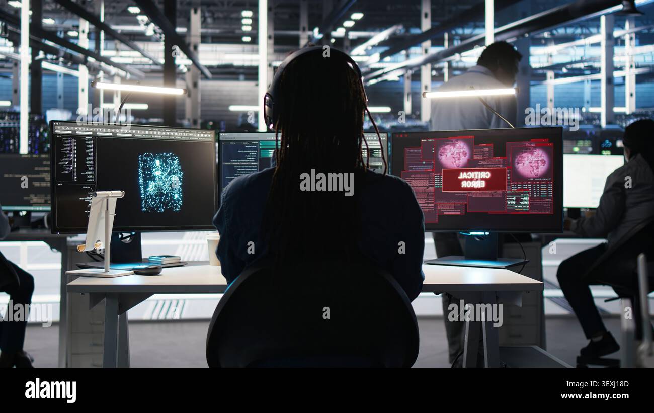 Data infrastructure center software programmer seeing urgent system alert message. Stock Photo
