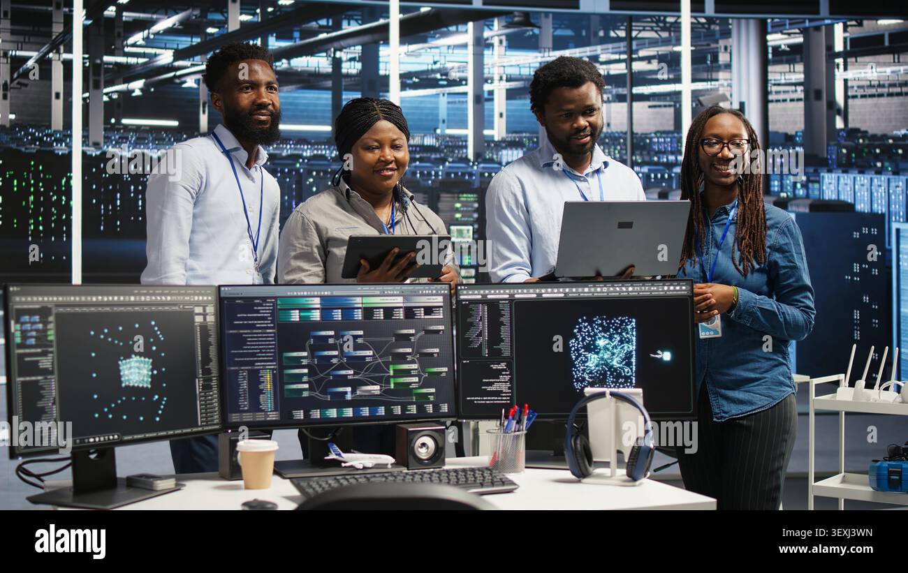 Engineers use a computer workstation in a server hub to categorize unstructured data with node tree systems. Stock Photo