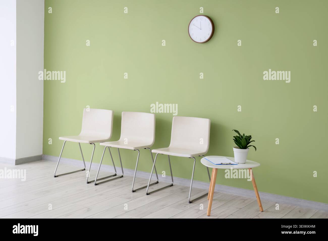 Empty waiting room with chairs and clock Stock Photo
