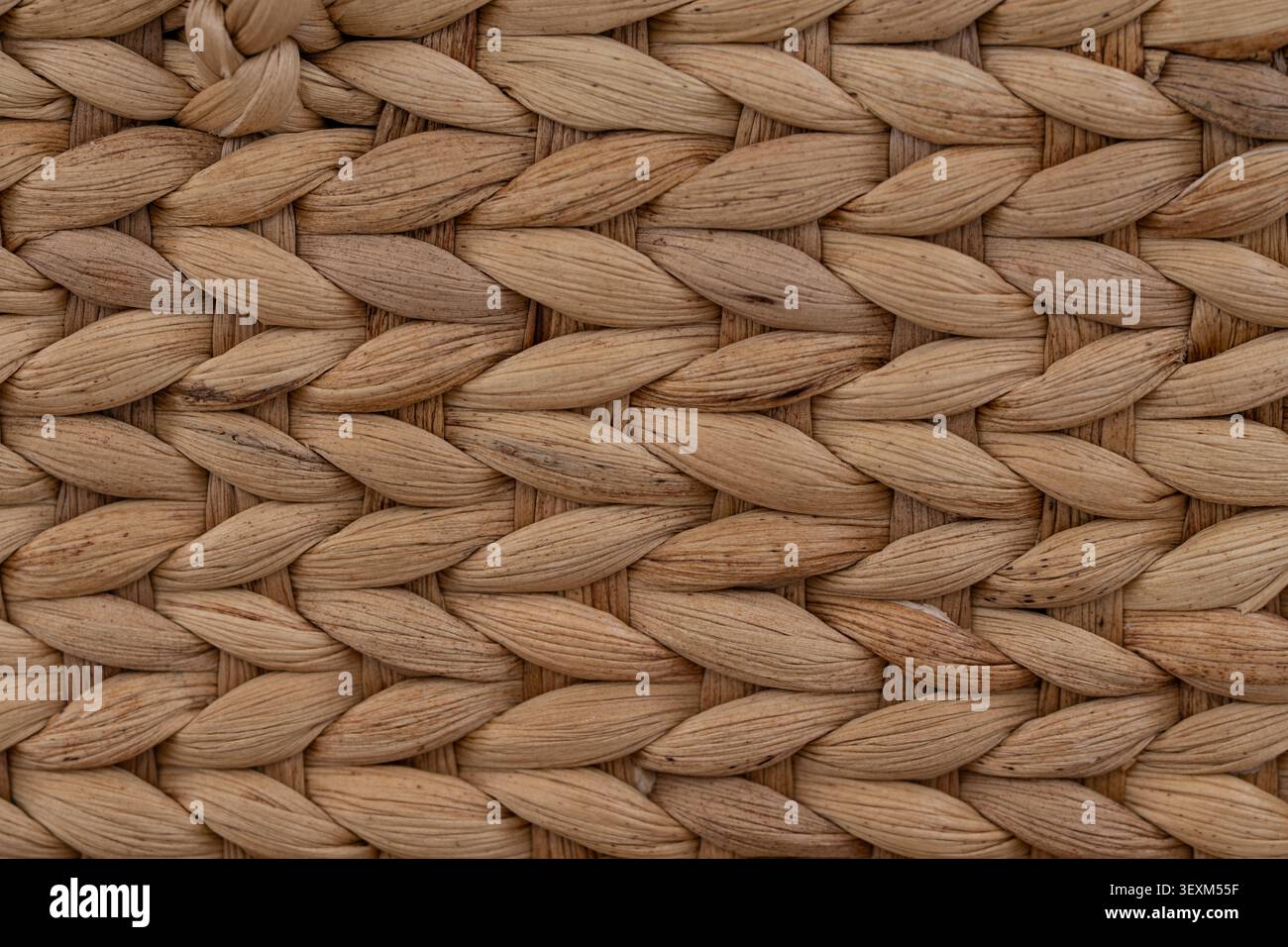 Close up macro texture of handwoven water hyacinth weave in natural earth tone background Stock Photo