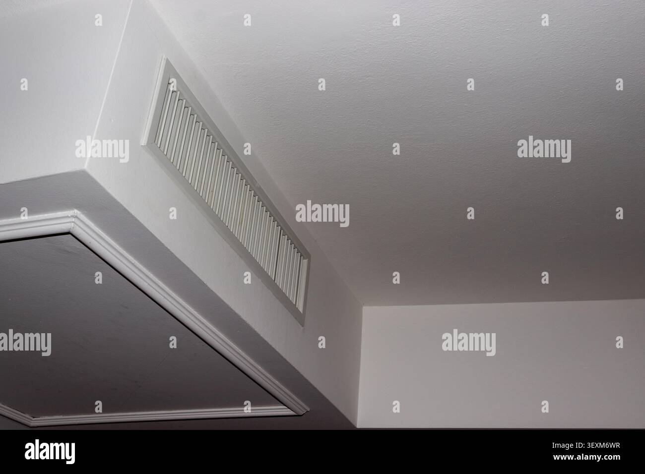 White Ventilation Grille in Modern Ceiling Architecture Stock Photo