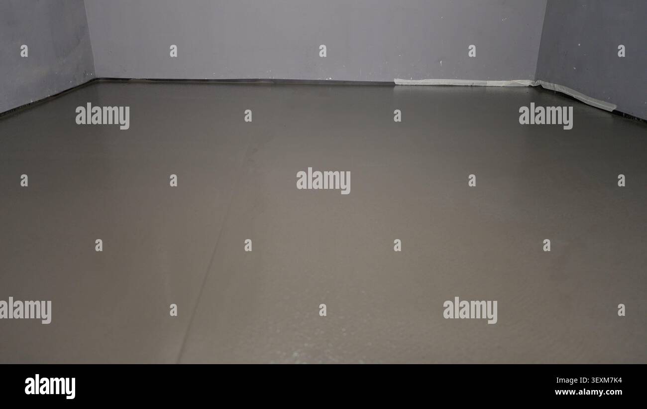 Wet self-leveling floor screed layer in room Stock Photo