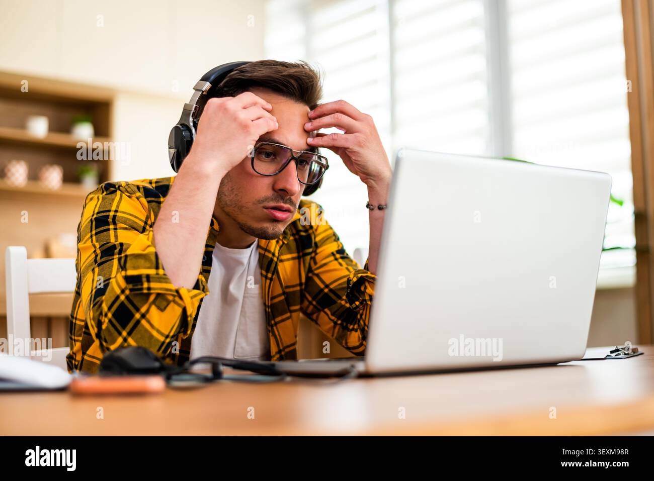 Freelancer working at home is having mental burnout. He is tired and overworked. Stock Photo