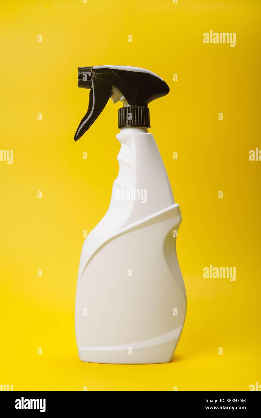 White Trigger Spray Bottle on Yellow Stock Photo