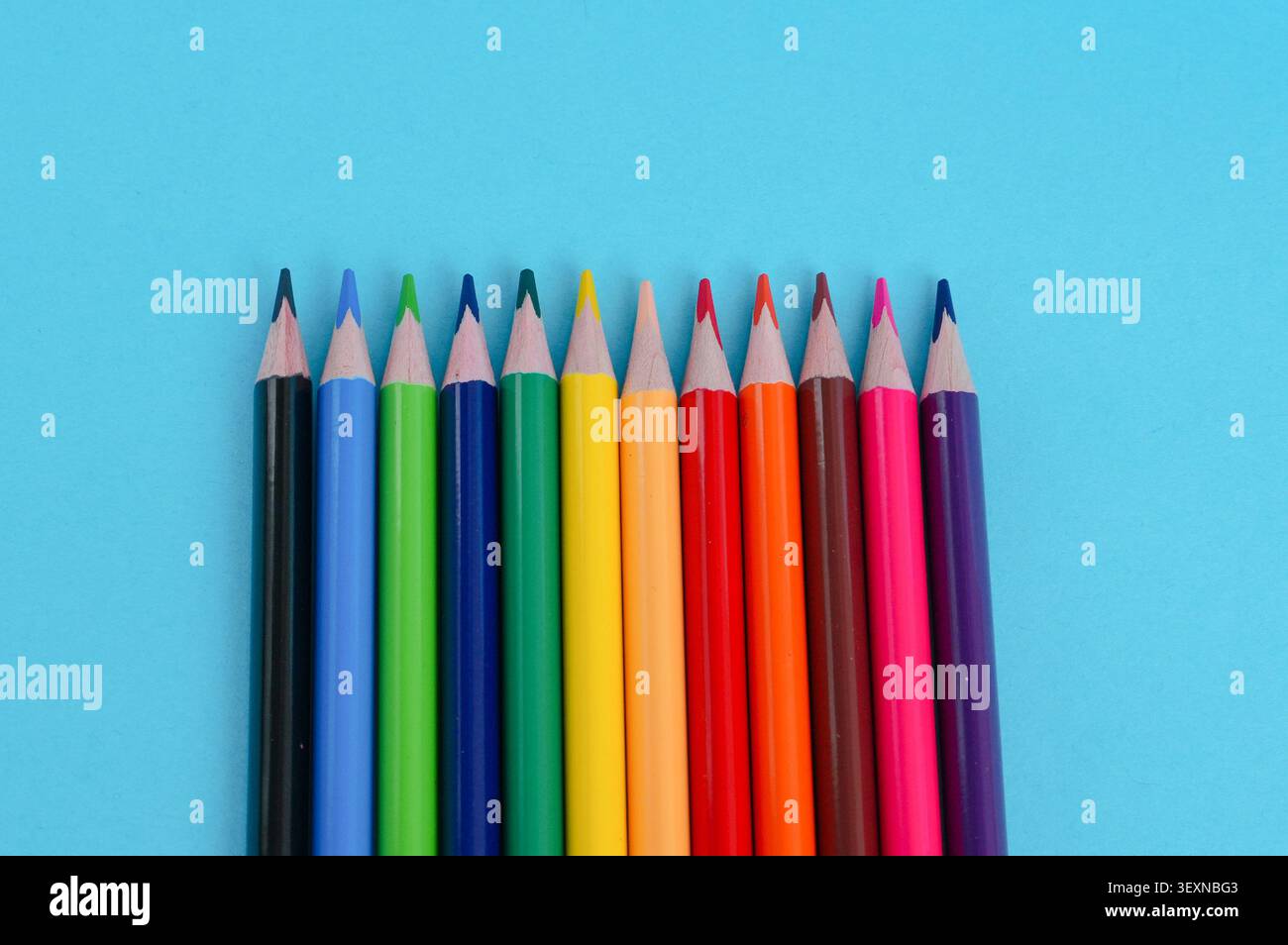 colored pencils on a blue background, close-up, copy space Stock Photo