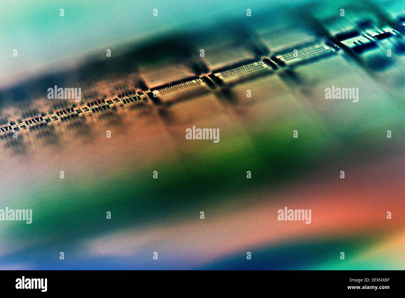Wafer surface displaying microchip components and electronic circuits in a blurred abstract composition Stock Photo