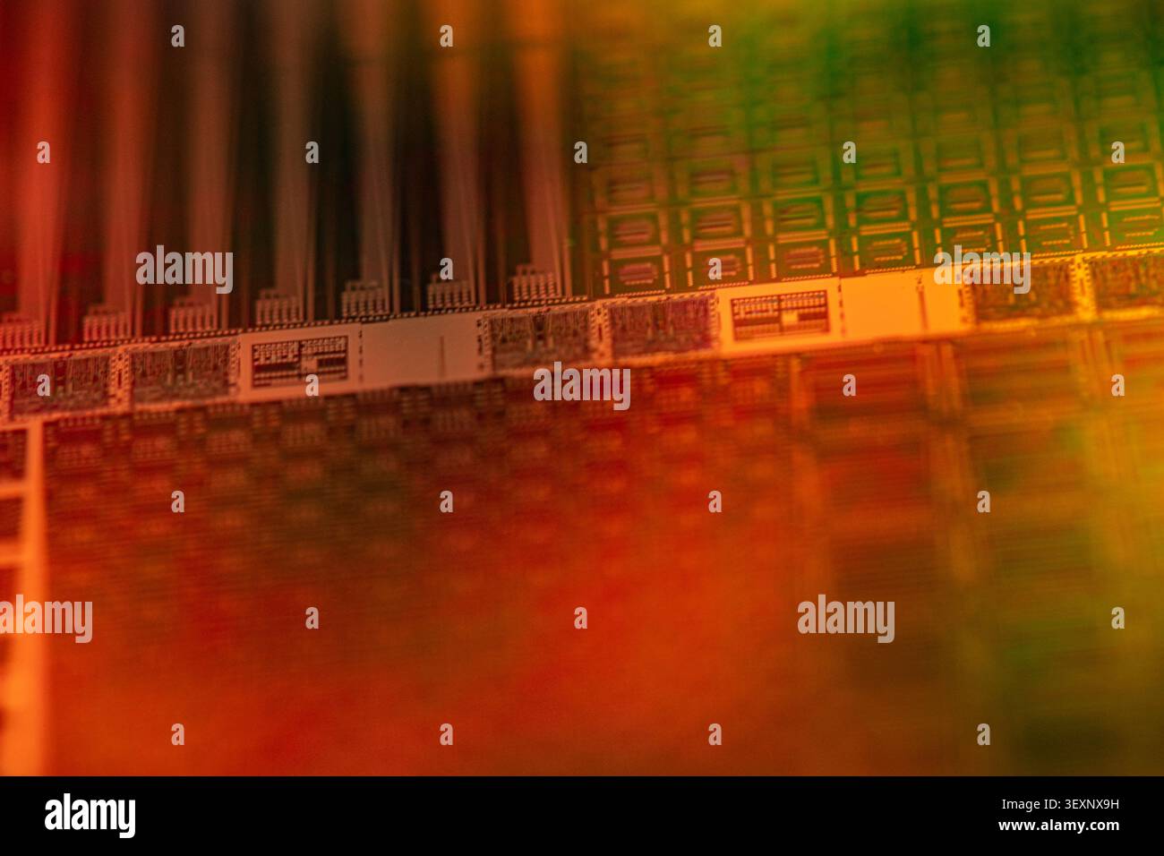 Wafer showing complex patterns of microchips on a semiconductor surface Stock Photo
