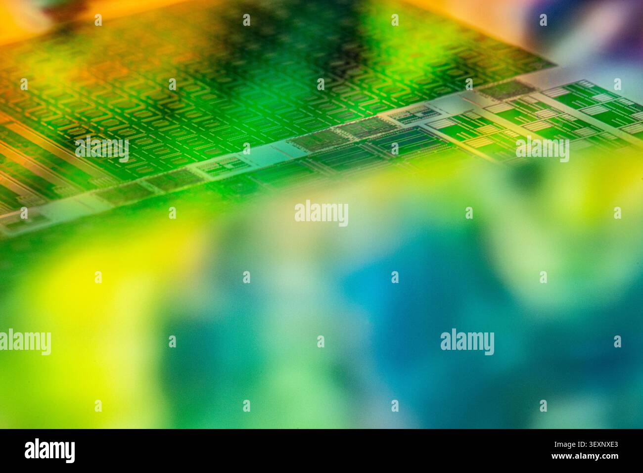 Silicon wafer reflecting multicolored light with microchip patterns Stock Photo