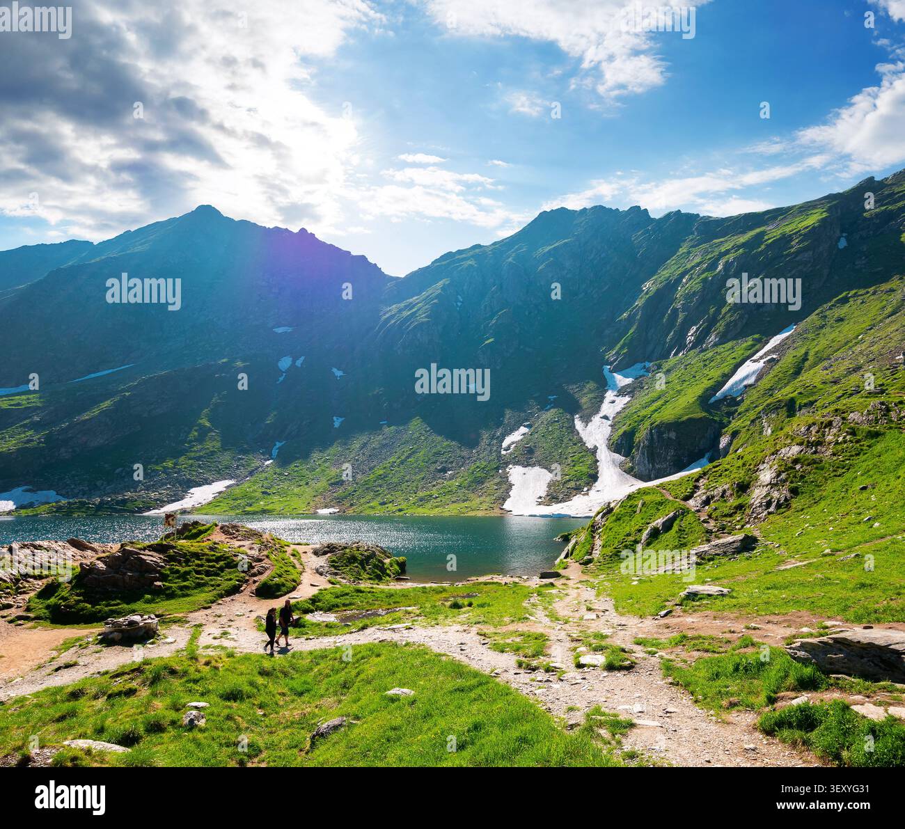 beautiful alpine scenery of fagaras mountains. balea lake in romania mountain landscape. summer weather with clouds on sky. view of rippled water near Stock Photo
