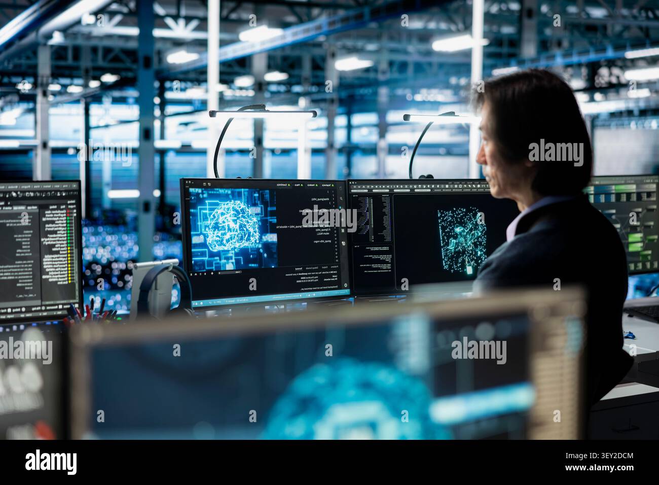 Data center programmer manages databases supporting AI applications and data mining in a server facility. Stock Photo