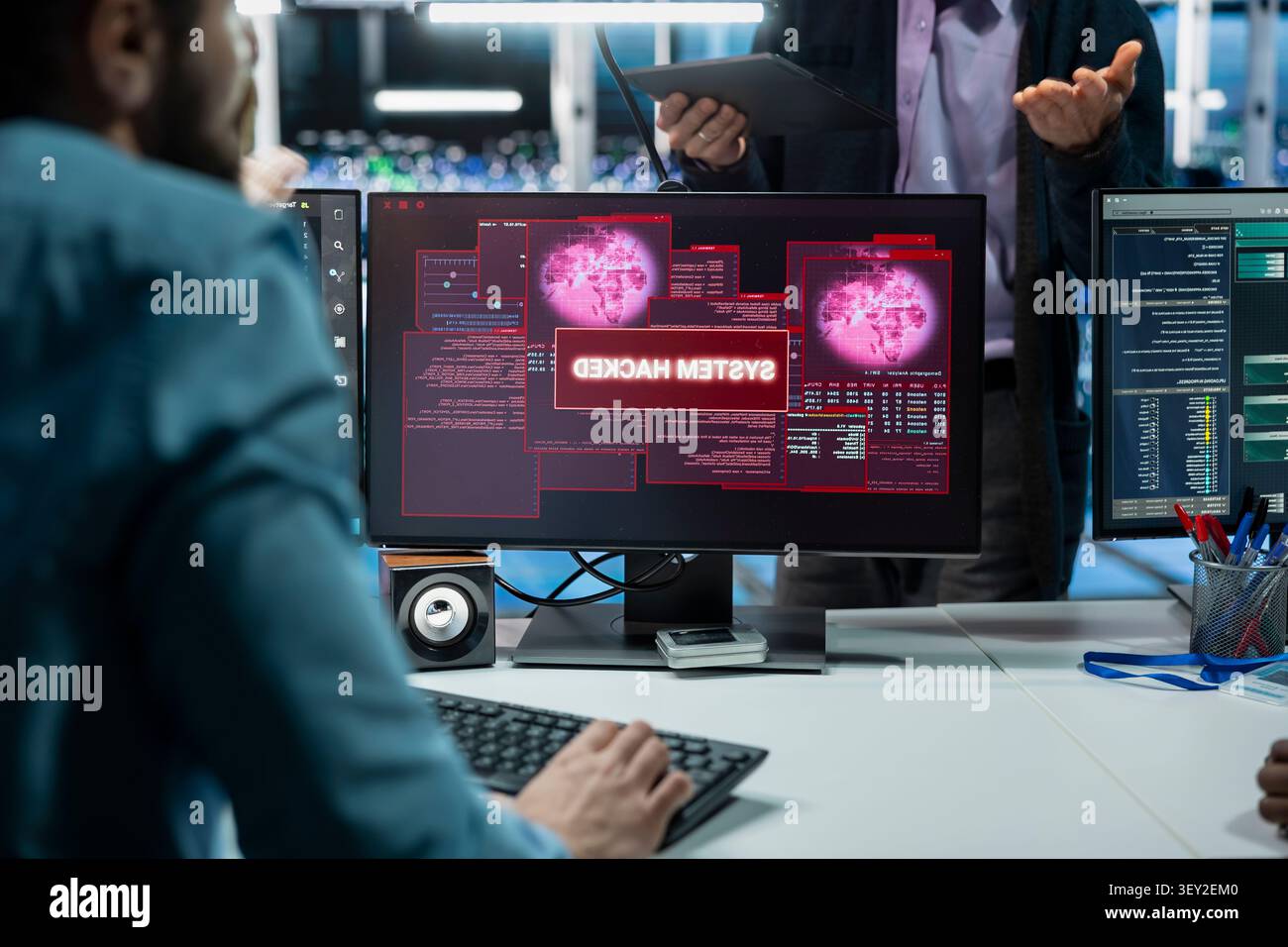 Programming team members improve security systems in a server farm with machine learning to help prevent breaches. Stock Photo