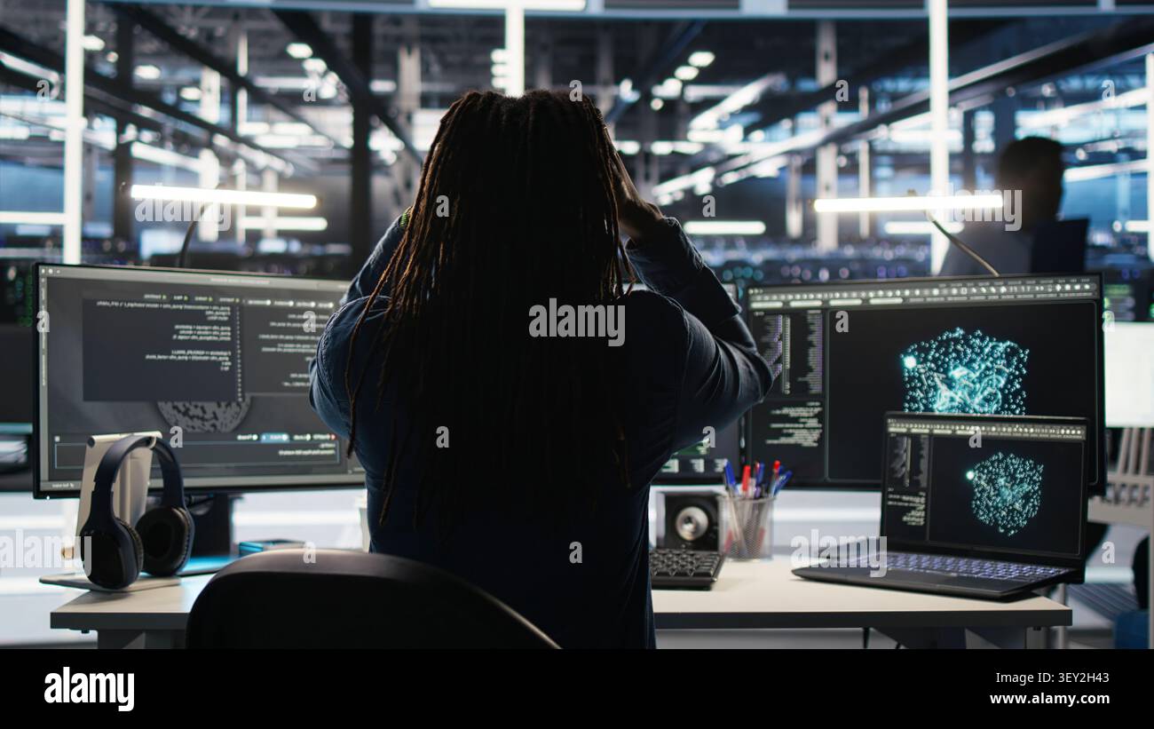Engineer reacts with frustration in a server farm as node tree systems fail to categorize unstructured data. Stock Photo