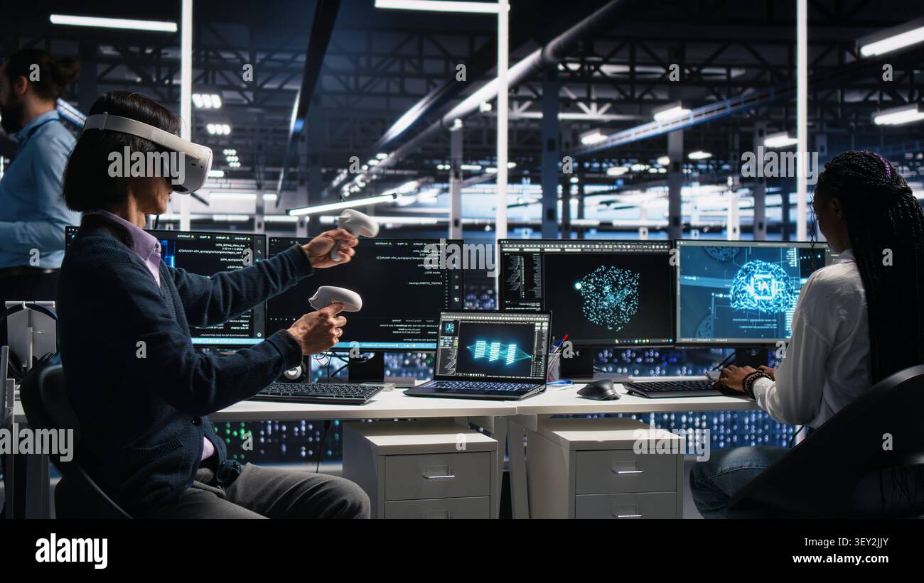 Computing facility technical specialist working with virtual reality, managing AI systems for uptime. Stock Photo