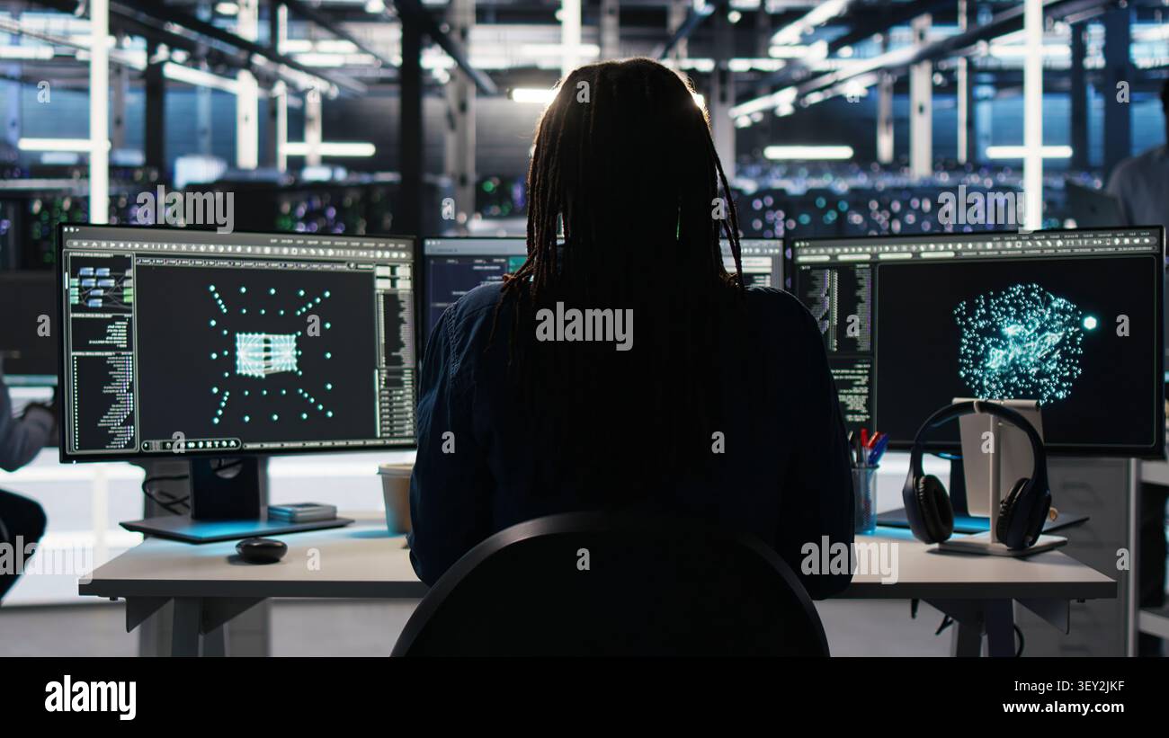 Computing facility computer scientist working with visual programming system to assess datasets with IT staff member working with visual programming to strengthen digital infrastructure performance. Stock Photo