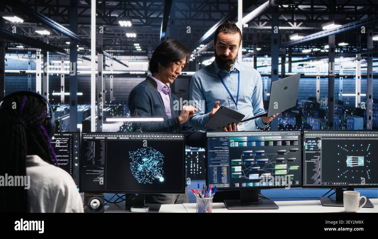 Data infrastructure center team supervisor supervising software developer. Stock Photo