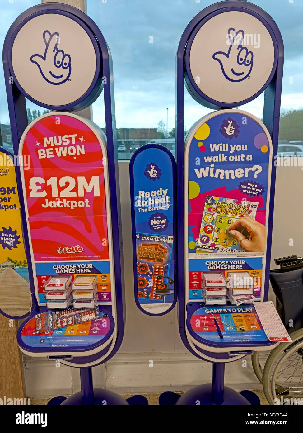 National Lottery promotional stands advertising a £12m jackpot in a UK retail outlet. Stock Photo