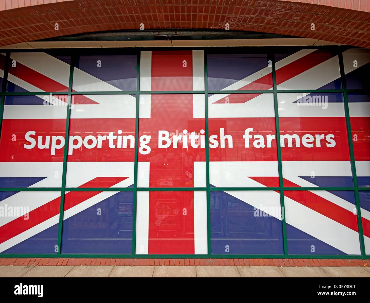 Morrisons Union Flag window advert with the slogan “Supporting British farmers” at its Warrington store near Stockton Heath Stock Photo