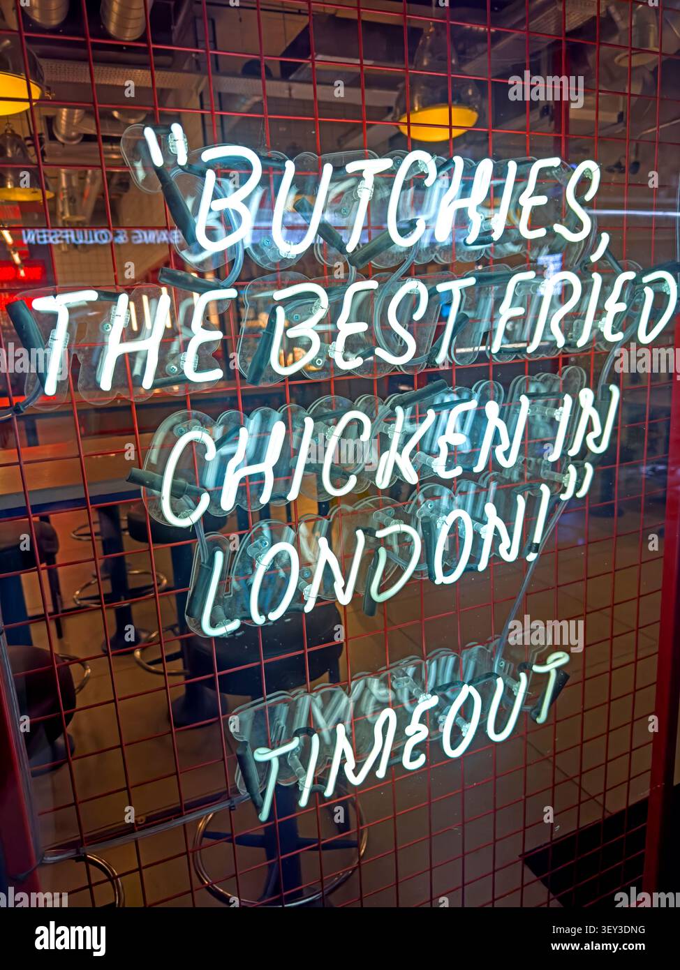 Neon Butchies sign promoting “The Best Fried Chicken in London” at the Bond Street restaurant near Ealing Broadway, west London Stock Photo