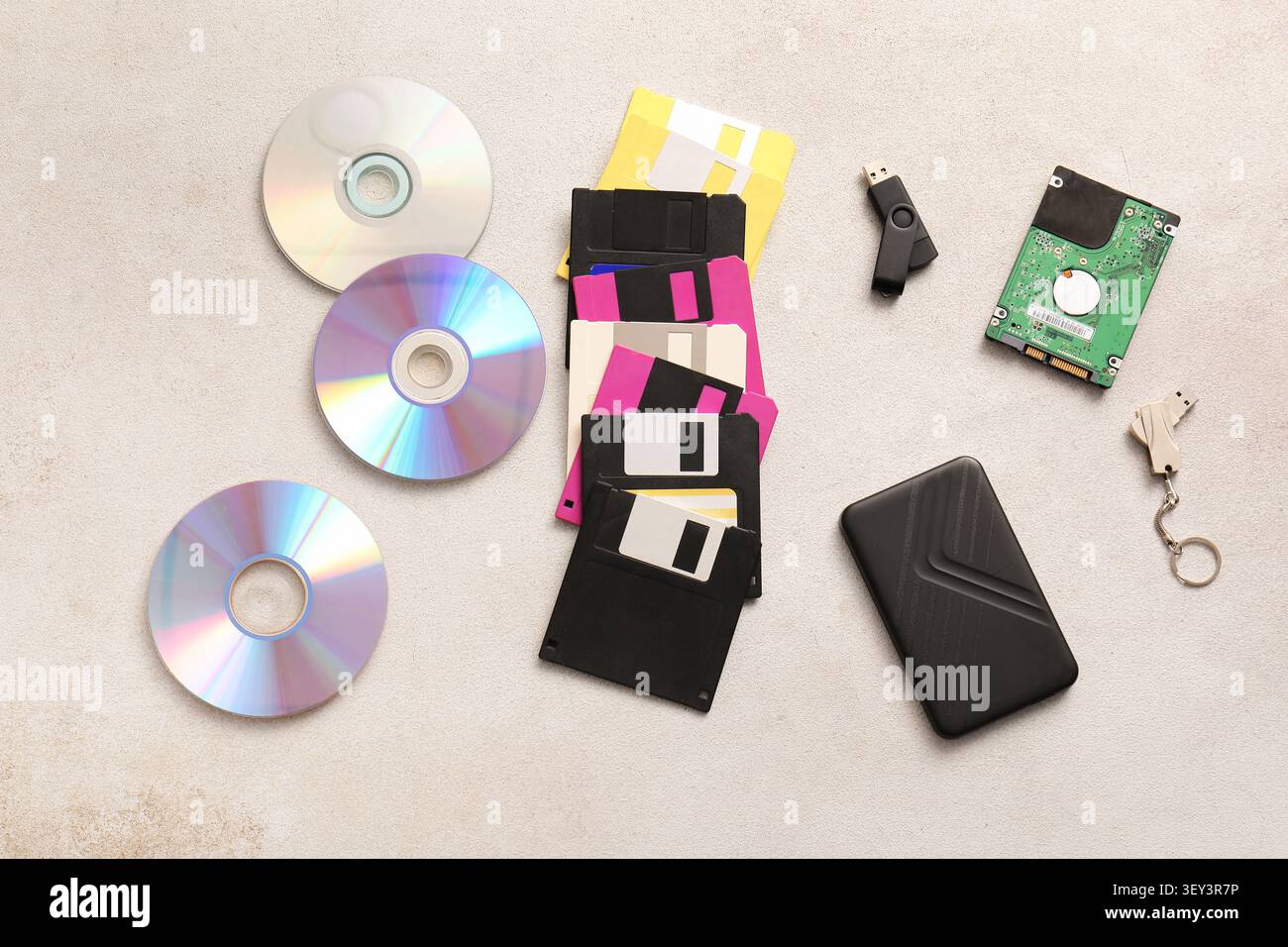 Various data storage devices on a beige surface Stock Photo