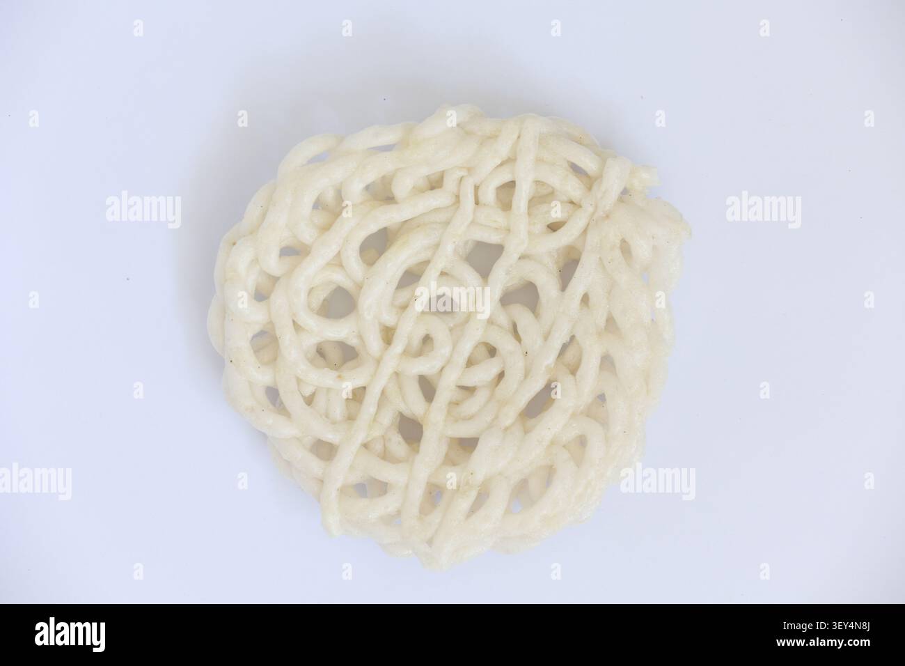 Round Indonesian Cracker with Net Pattern Isolated on White Background Stock Photo