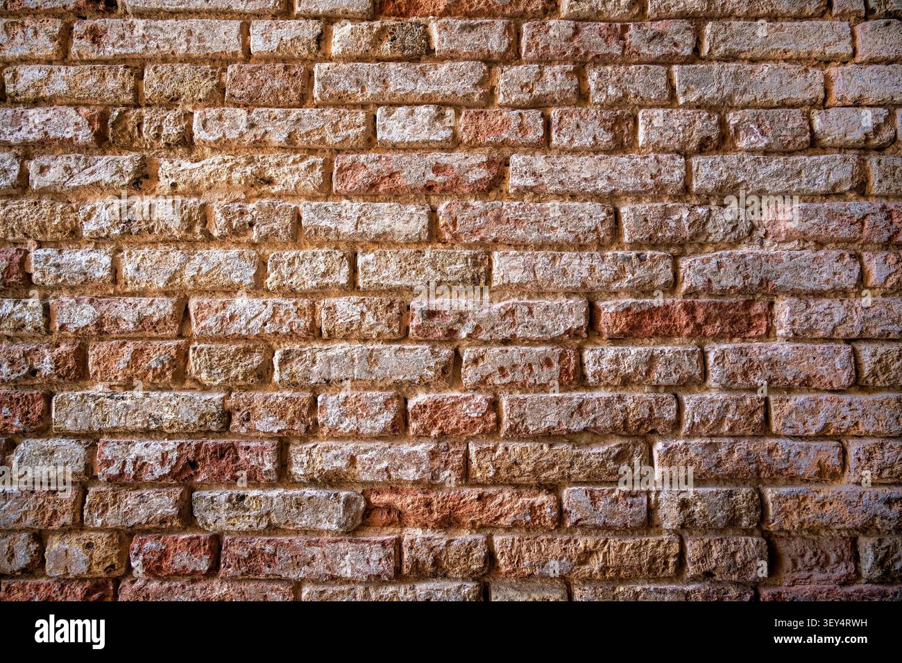 Old worn faded brick wall background texture Stock Photo