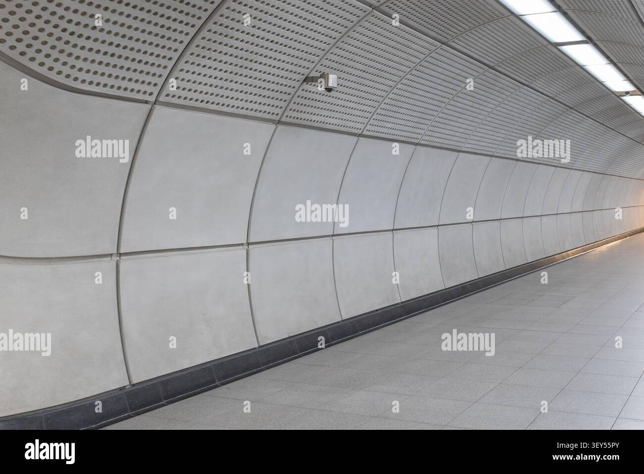 Curved concrete panel wall in an underground station Stock Photo