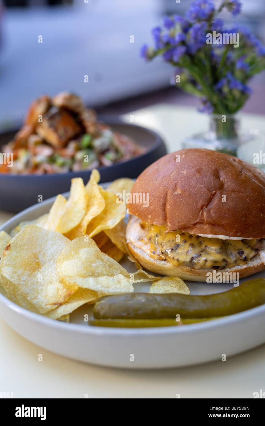Cheeseburger and Chips Restaurant Presentation Close-Up Stock Photo