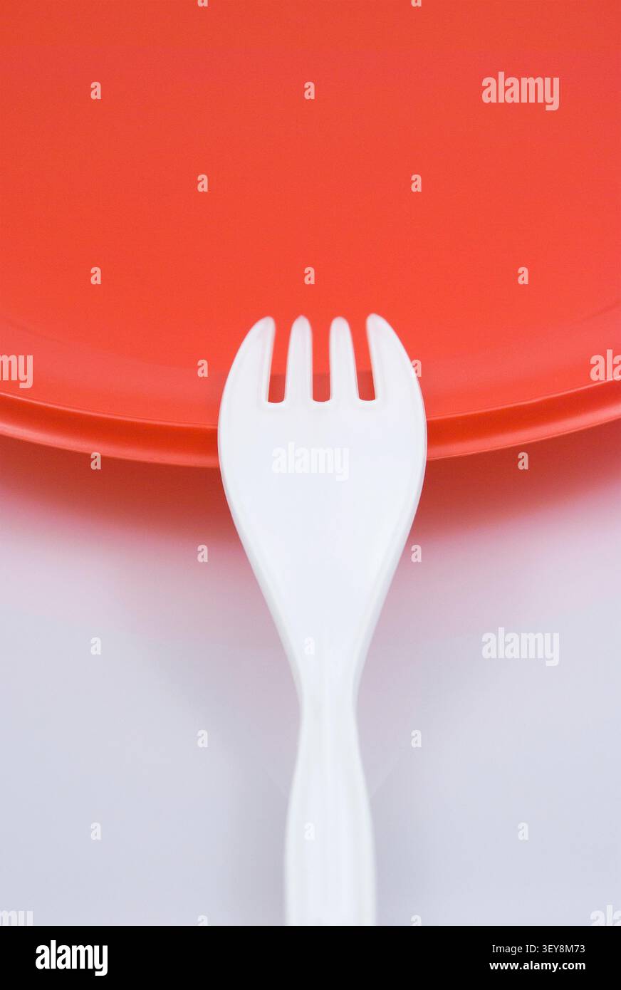 disposable fork and red dish Stock Photo