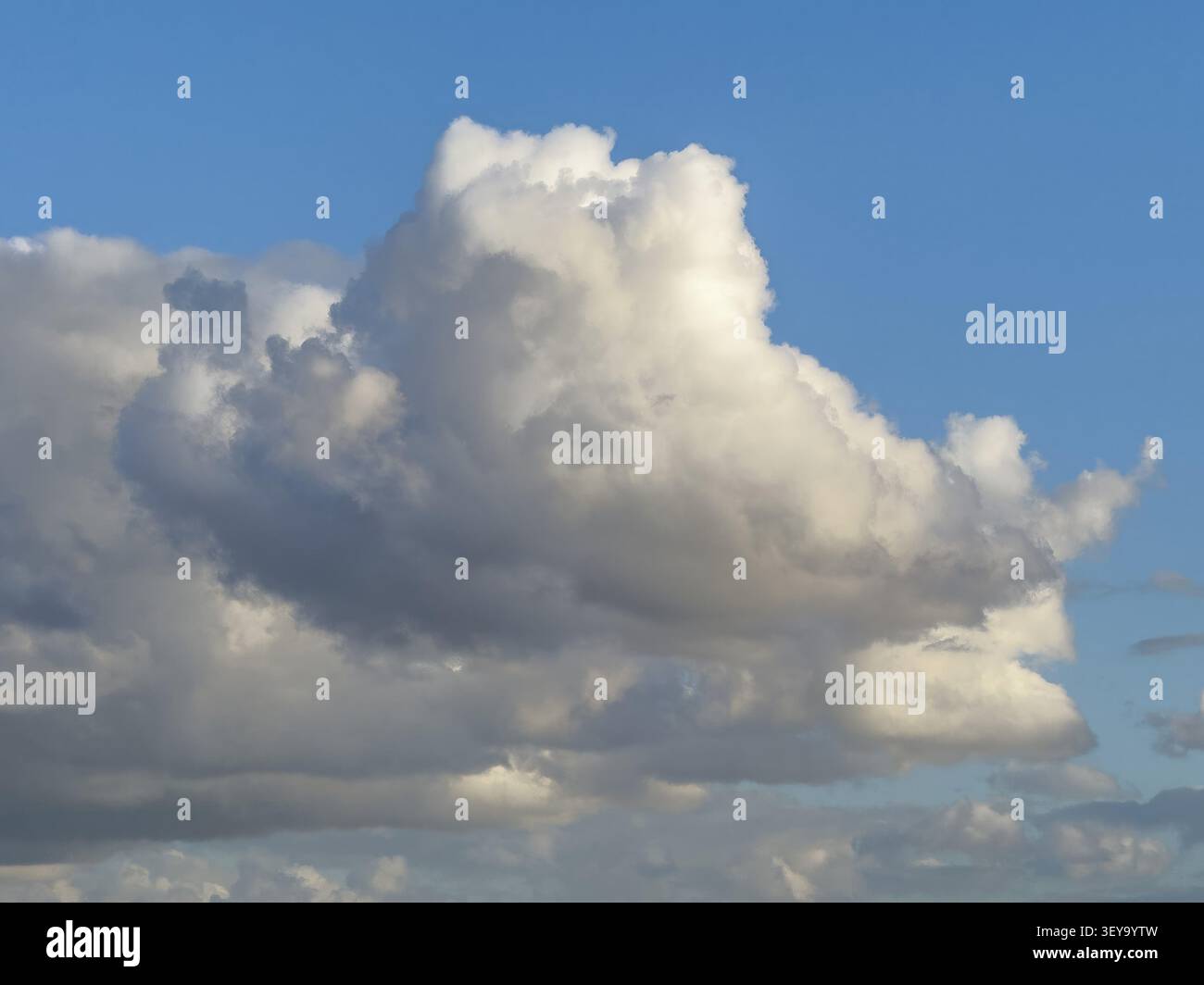 Large white cloud Cumulus cluster cloud against blue sky, Germany Stock Photo