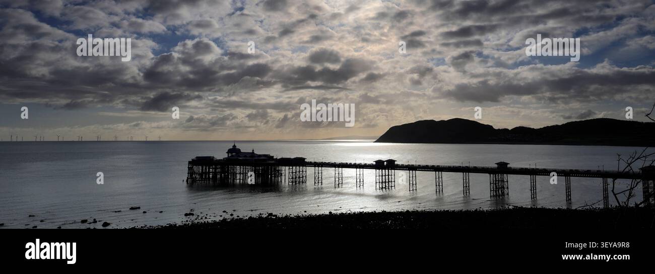 Dramatic clouds over Llandudno Pier and The Little Orme, Llandudno town, Conwy, North Wales, Britain. Stock Photo