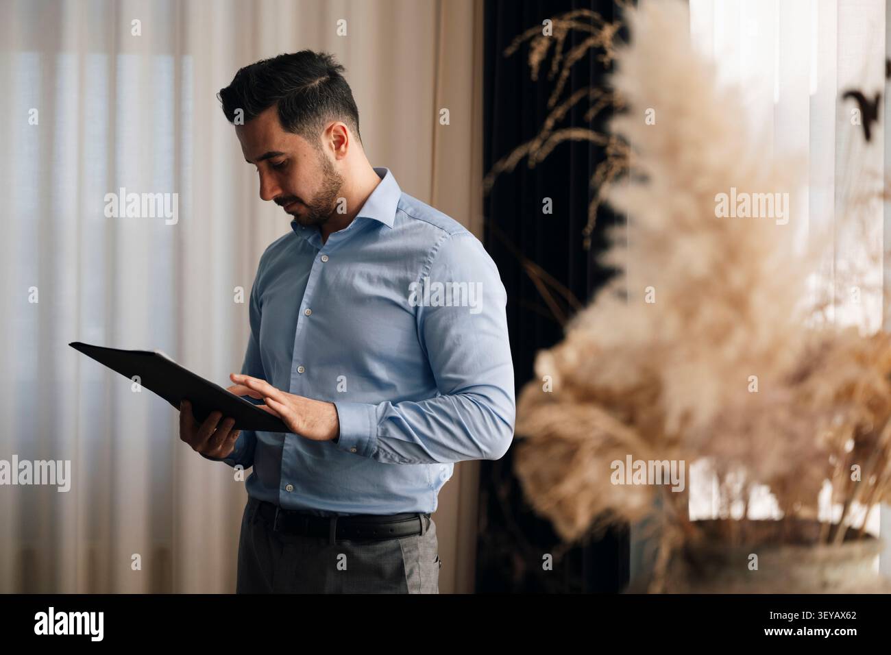 Businessman reviewing documents while working at office Stock Photo