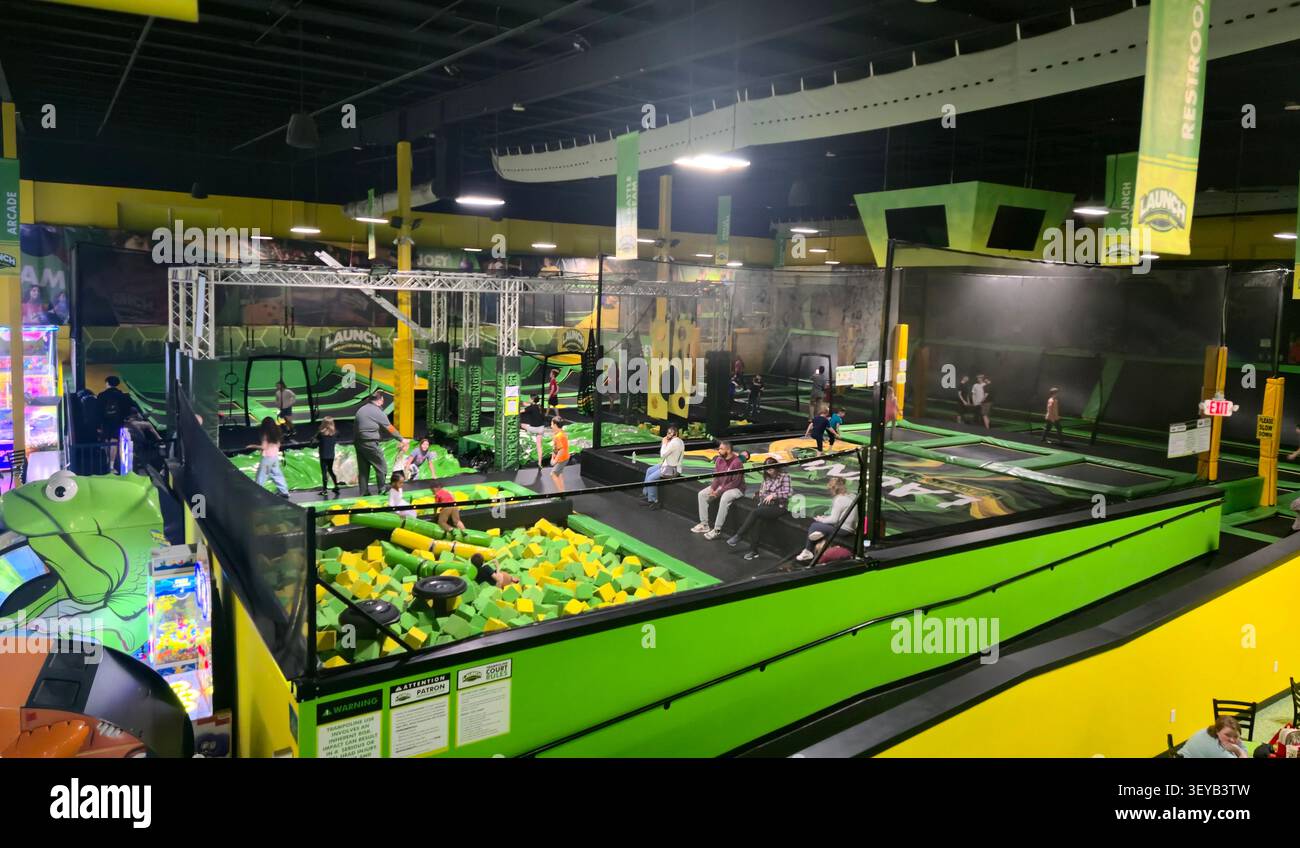 Children and families enjoy trampolines and foam pits at Launch Trampoline Park - Smartphone Captured Stock Image